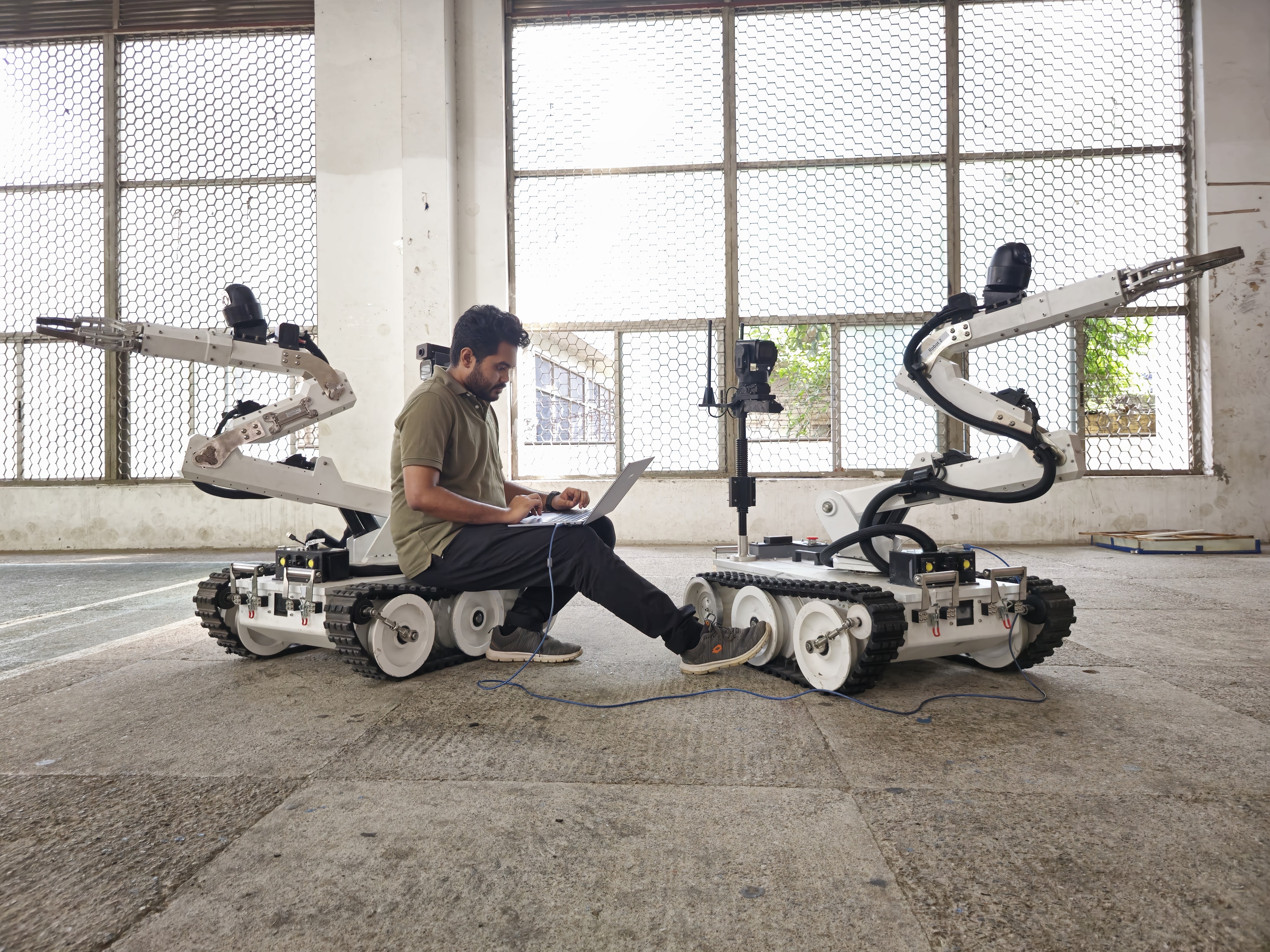 Fahim Ahmad between two EOD robots